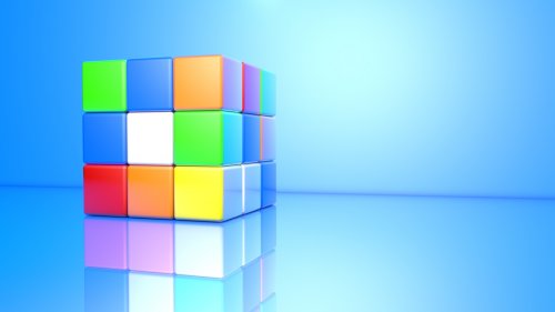 Кубик Рубика на голубом фоне и его отражение
